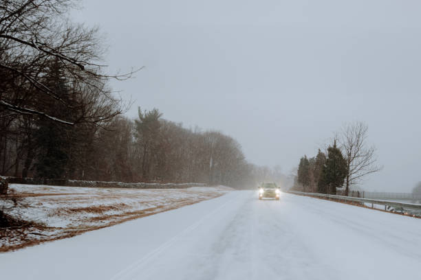 istock Car on the road with snow 1200443660
