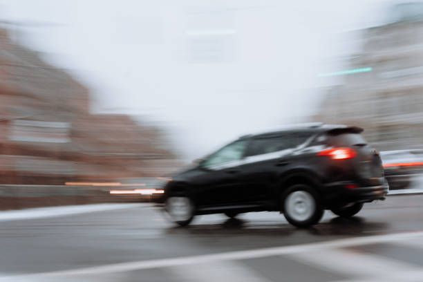 istock Car on the road with snow 1200443722