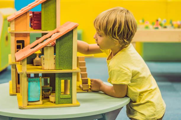 istock Boy playing with wooden house in kindergarten 1200447997