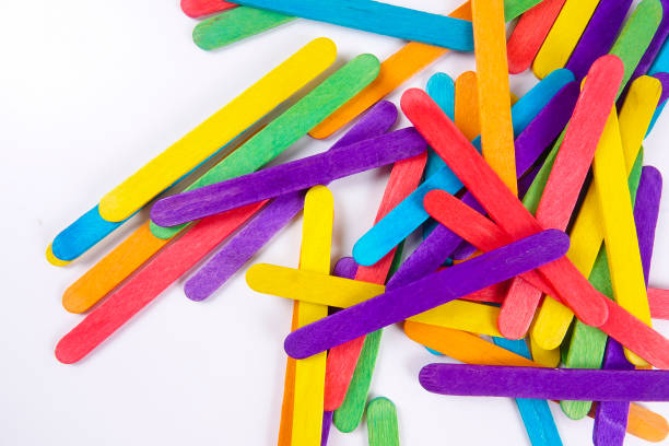 istock Colourful wooden sticks on white background 1200448310
