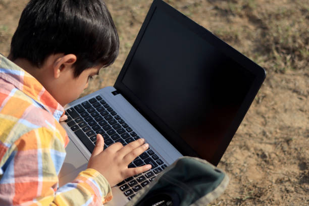 istock Child using laptop outdoor in nature 1200452756