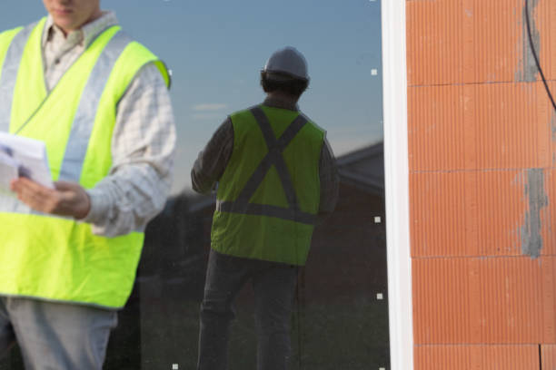 istock Professional engineer architect worker with protective helmet at house building construction site background 1200469924