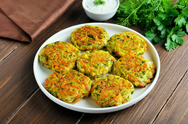 istock Vegetable cutlets from zucchini, carrot, herbs in white plate 1200469932