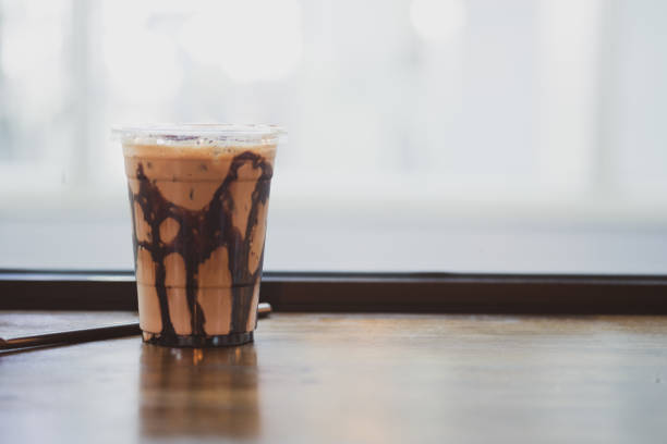 istock Delicious iced mocha in clear plastic glass on wood table 1200470655