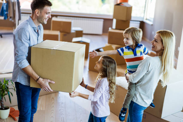 istock Young happy family communicating while relocating into new home. 1200474254