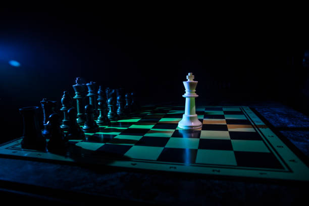 istock Chess figures on a dark background with smoke and fog. Selective focus 1200475167