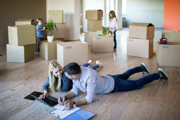 istock Happy parents talking while making plans on the floor at new apartment. 1200475810