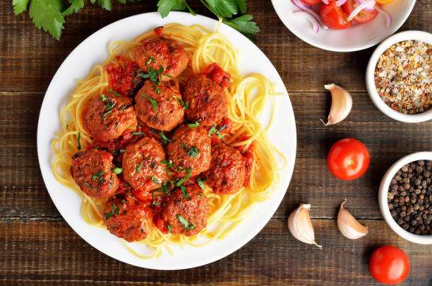istock Fried meatballs and spaghetti on plate, tomato sauce and spice 1200476648