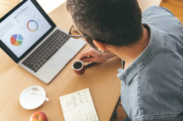 istock man checking business stats at laptop 1200477053