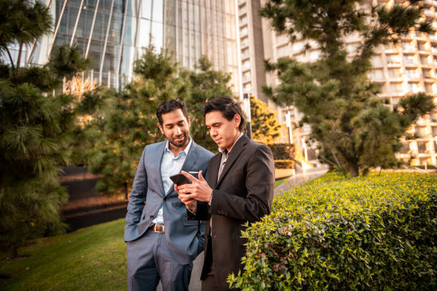istock Two colleagues walking in the business district 1200478911