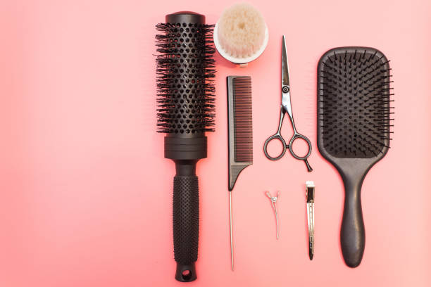 istock Flat lay composition with hairdresser set on pink background. Barber set with tools and equipment: scissors, combs and hairclips with copy space for text in left. Hairdresser and beauty salon service 1200479744