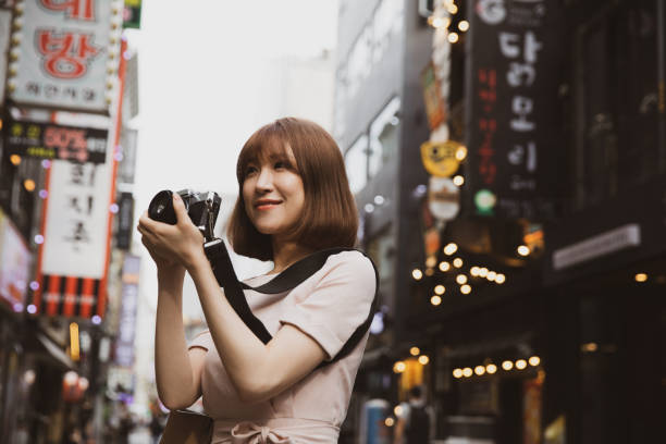 istock Young woman exploring Seoul downtown 1200481296