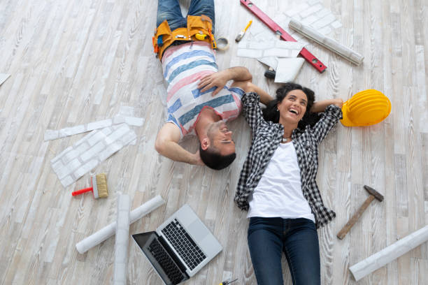 istock Couple renovating and resting on floor 1200482864