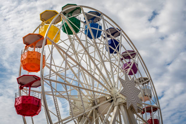 istock Colorful ferri wheel on a blu and white sky background 1200485463