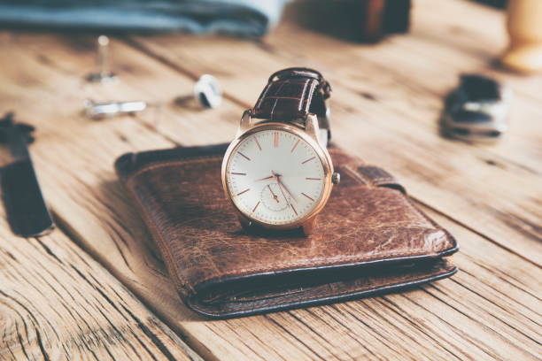 istock watch on wallet on the wooden desk background 1200486768