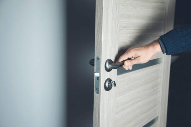 istock young man opening room door on brown background 1200486816