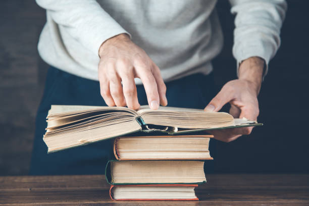 istock man reading book on the wooden desk 1200488265