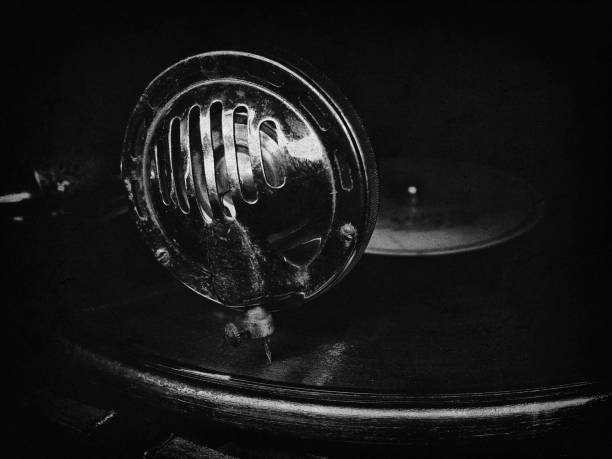 istock Head with an old gramophone needle on the vinyl disc closeup 1200490623