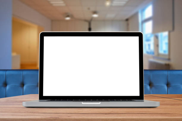 istock Laptop on wooden desk against office background 1200491347