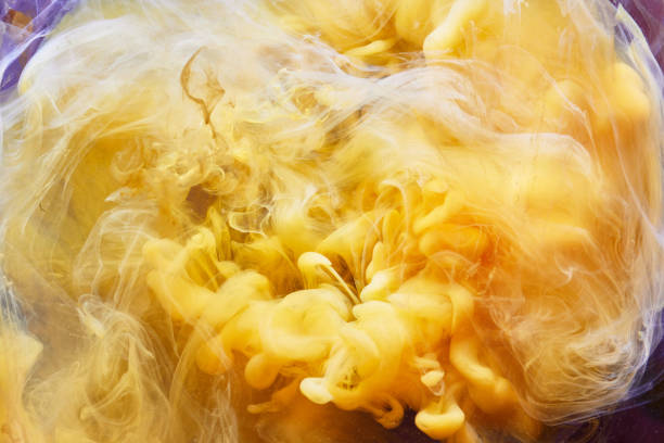 istock Yellow Liquid Swirling Chemical Smoke Background 1200492730
