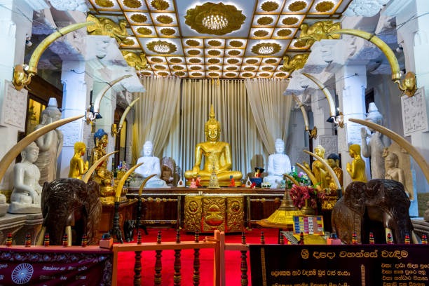Altar and buddha statue inside of the Sri Dalada Maligawa or the Temple of the Sacred Tooth Relic, a Buddhist temple in the city of Kandy, Sri Lanka. which houses the relic of the tooth of the Buddha. stock photo