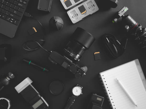 istock top view of work space photographer with digital camera, flash, cleaning kit, memory card, tripod and camera accessory on black table background 1200499371