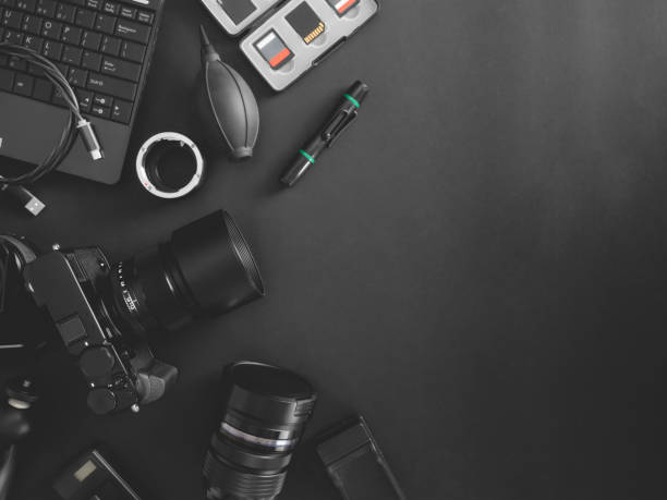 istock top view of work space photographer with digital camera, flash, cleaning kit, memory card, tripod and camera accessory on black table background 1200499375