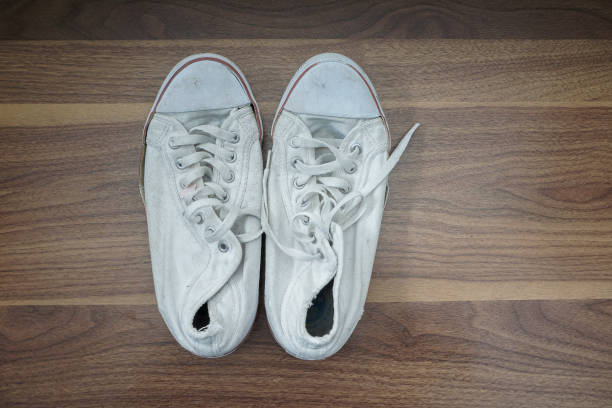 istock old shoes on wooden table, 1200504531