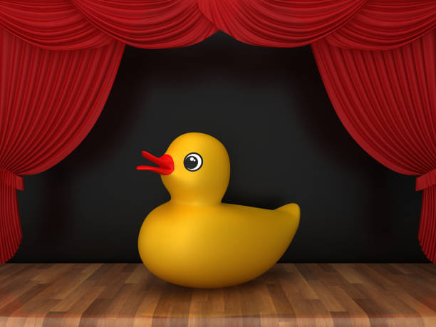 istock Red Stage Curtains with Rubber Duck on Wood Floor - 3D Rendering 1200508594
