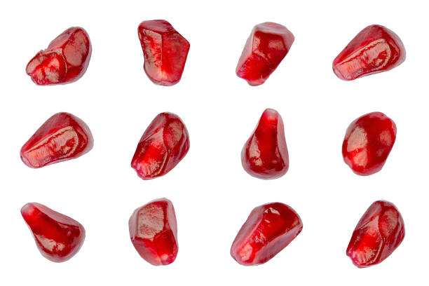 istock Pomegranate seeds isolated on a white background, top view. Pomegranate seeds isolated on a white background. Set of pomegranates isolated on a white background. Top view of pomegranate seeds. 1200510319