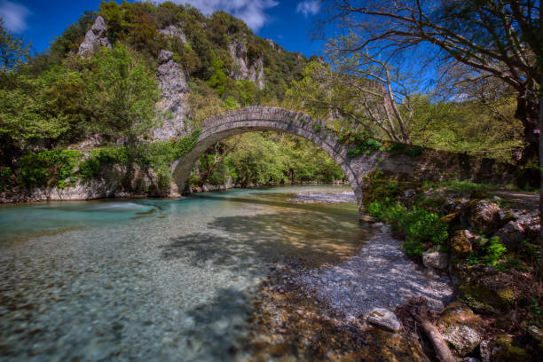 Old stone bridge in Klidonia Zagori, Epirus, Greece. Old stone bridge in Klidonia Zagori, Epirus, Western Greece. This arch bridge with elongated arch built in 1853. zagori stock pictures, royalty-free photos & images