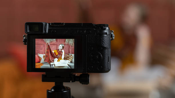 istock Young adult vlogger recording video on dslr camera 1200512403