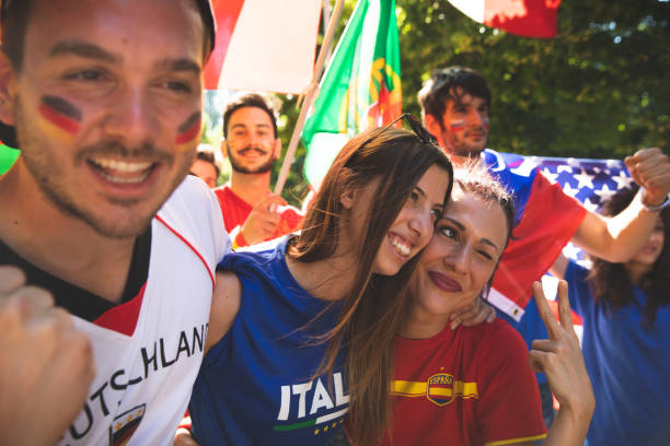 istock Different soccer fans celebrating together on the match day 1200513761