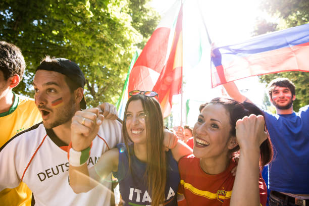 istock Different soccer fans celebrating together on the match day 1200513827