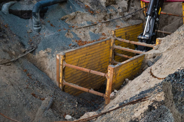 Keeping workers safe during trenching and excavation with safety equipment Keeping workers safe during trenching and excavation with safety equipment while doing construction work trench stock pictures, royalty-free photos & images