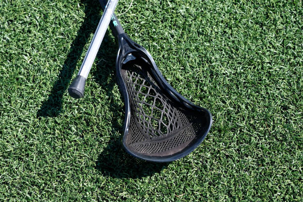 istock Various styles and colors of Lacrosse sticks on artificial turf during a womans Lacrosse tournament 1200524904