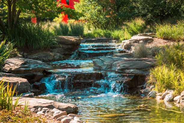Water cascading down a stream on a summer day in the Frederik Meijer Gardens stock photo