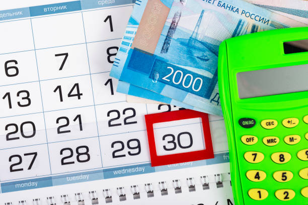 istock Calendar with a allocated 30 number, Russian two two-thousand bills, calculator 1200526307