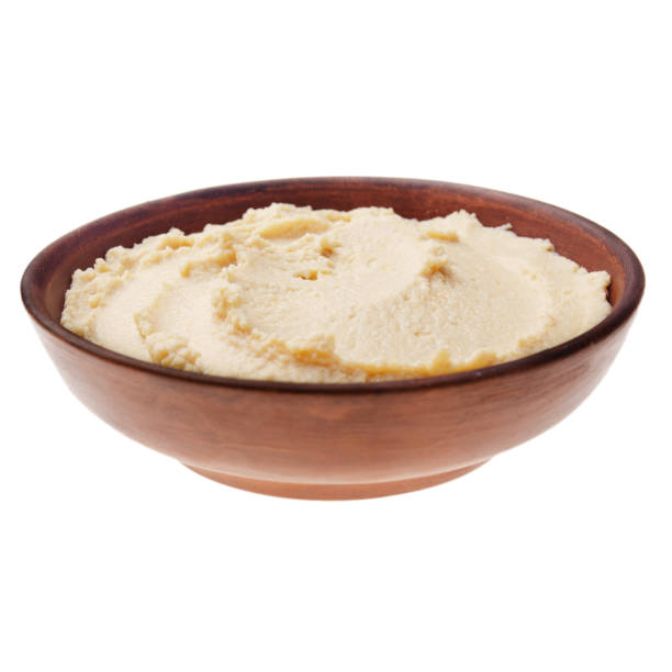 istock Plate with hummus - spread made from cooked, mashed chickpeas blended with tahini, lemon juice, and garlic isolated on white background. Clipping path added 1200526793