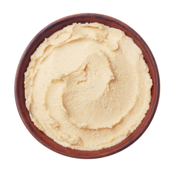 istock Flat lay view at hummus - spread made from cooked, mashed chickpeas blended with tahini, lemon juice, and garlic isolated on white background. Clipping path added 1200527926