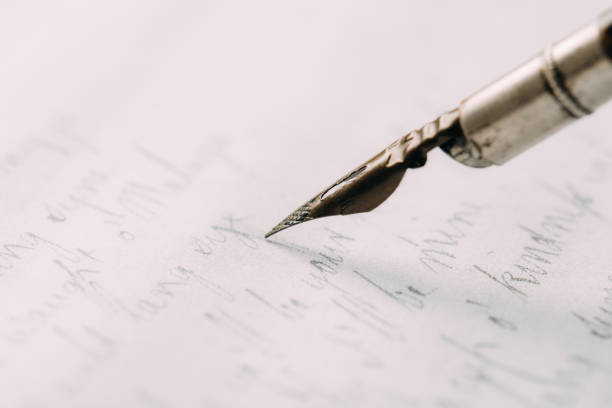 istock fountain pen on paper with ink text closeup 1200528249