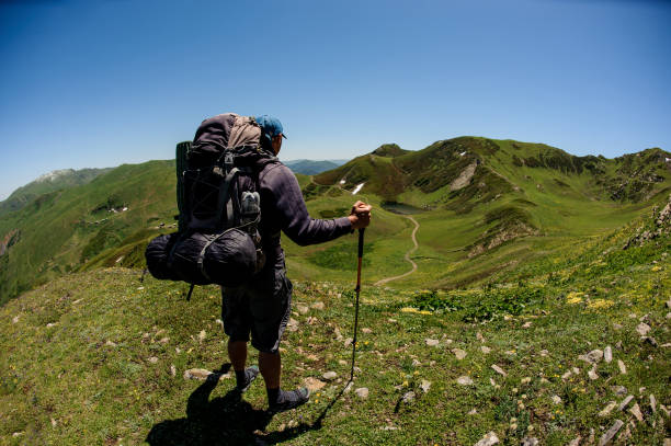 istock Tourist with special equipment stands on a meadow 1200529338