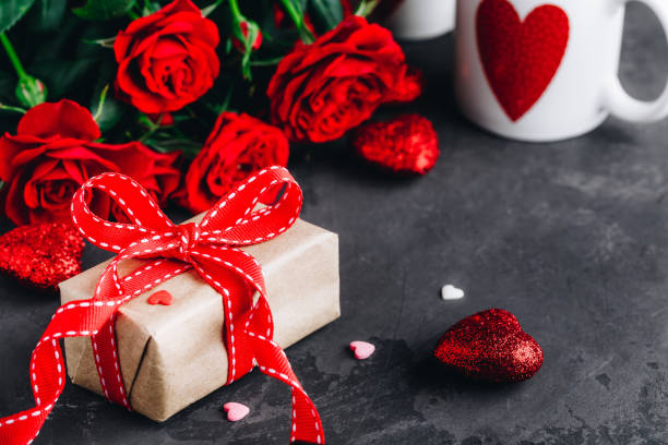 istock Valentines day background with red roses, present box and red hearts 1200529339