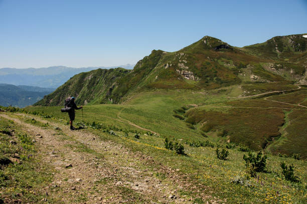 istock Traveller standing near the path in hills 1200529365