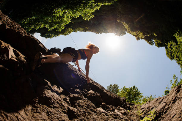 istock Female climbs up on the rock wall 1200530858