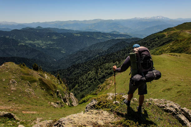istock Hiker stands on the top of the mountain 1200530988