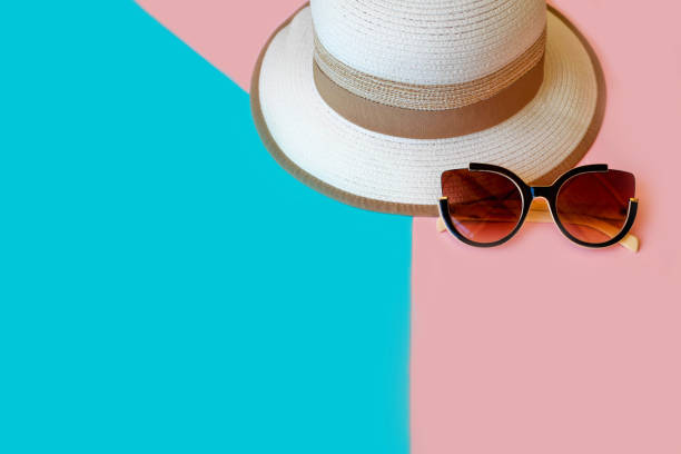 istock Hat and sunglasses on a pink blue background. 1200531212
