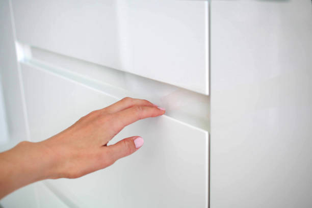 istock The woman hand opens modern door white kitchen with the hidden handle 1200531237