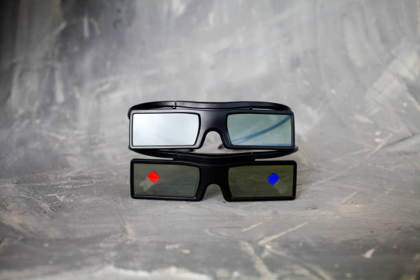 istock Two glasses 3 d lie on each other on a gray background. Copy space. Cinema in 3d 1200535755