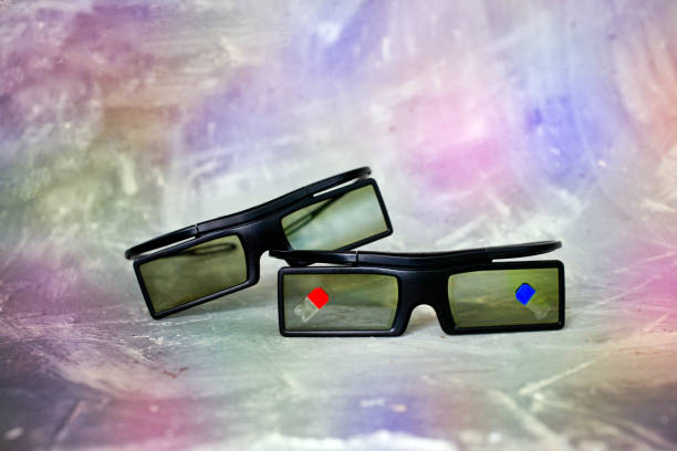 istock Two plastic 3 d glasses lie on each other onon the colorful background, with 1200535913